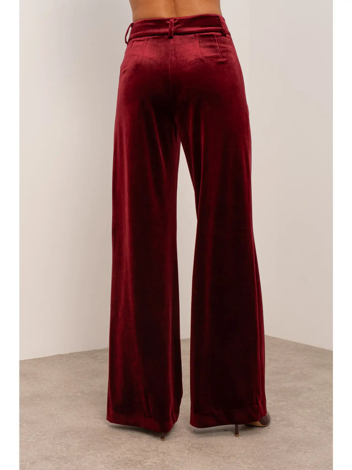 Maroon velvet wide-leg pants on a neutral background