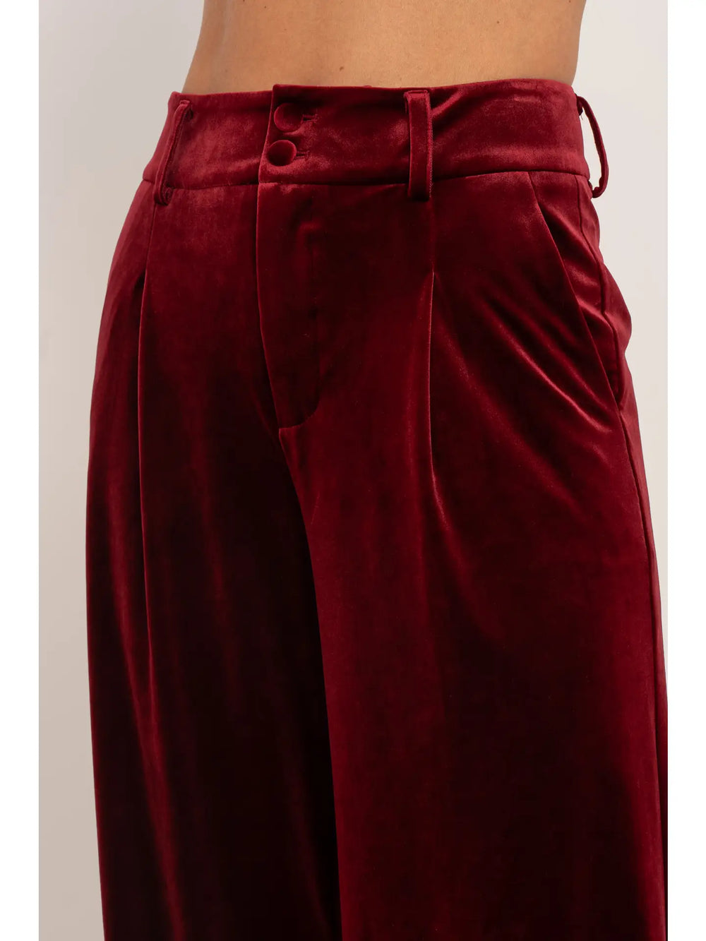 Maroon velvet pants with a plain background