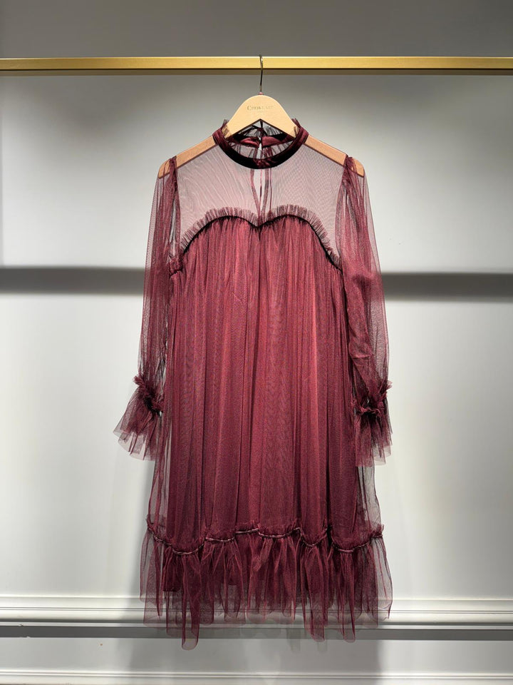 Maroon tulle dress on a hanger against a neutral background