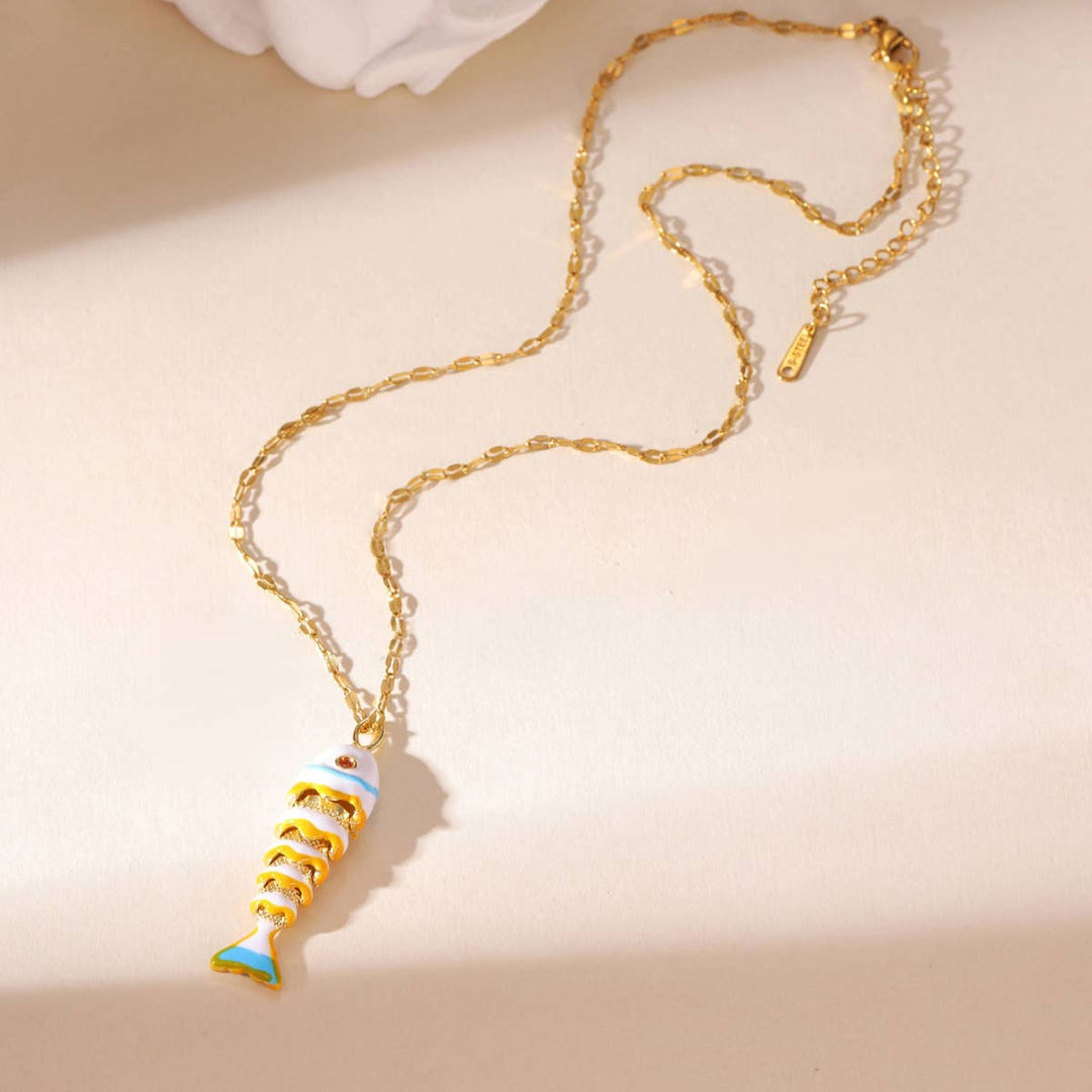 Gold necklace with a colorful pendant on a beige background