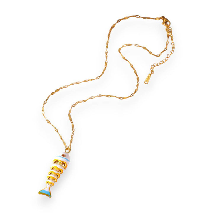 Gold necklace with a unique pendant on a white background