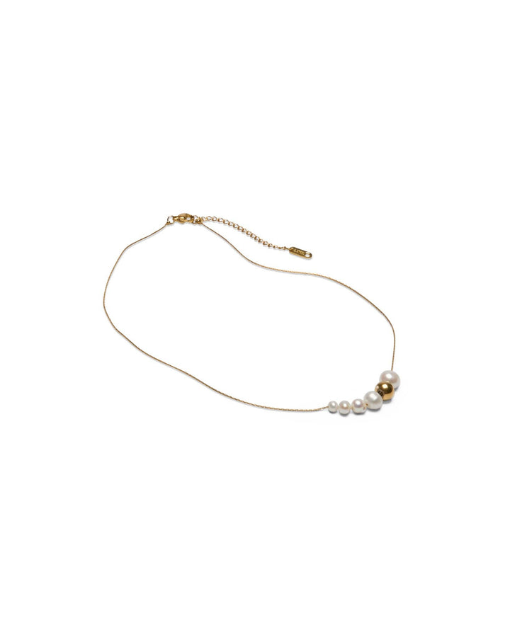 Gold necklace with pearls on a white background
