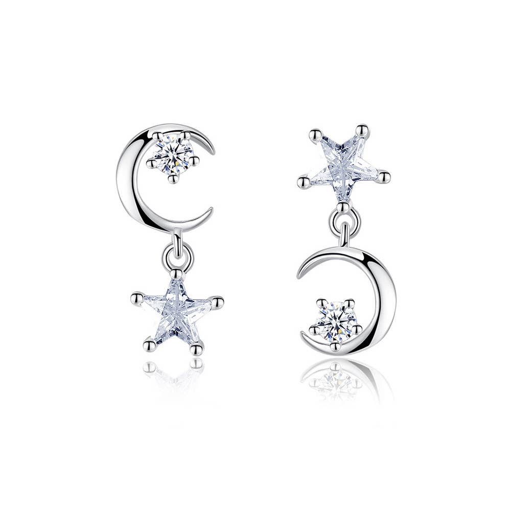 Pair of silver earrings with star and moon designs on a white background