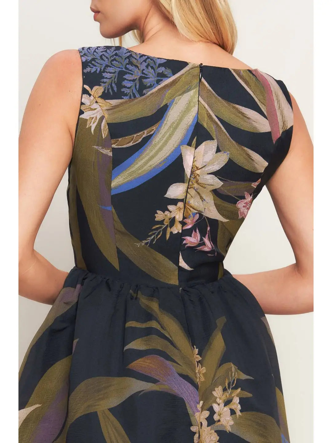 Woman wearing a floral dress with a neutral background