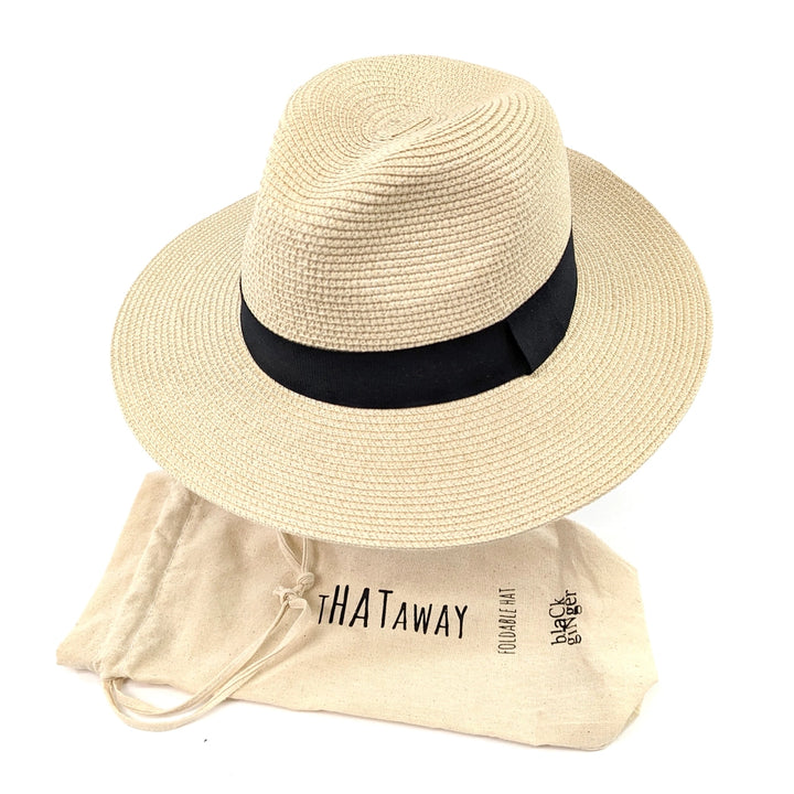 Beige straw hat with black band and beige drawstring bag labeled 'THATaway' on a white background
