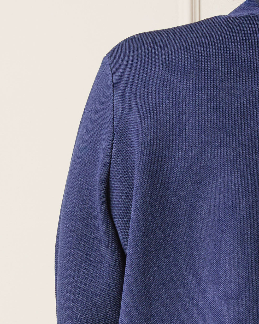 Close-up of a blue textured garment on a light background