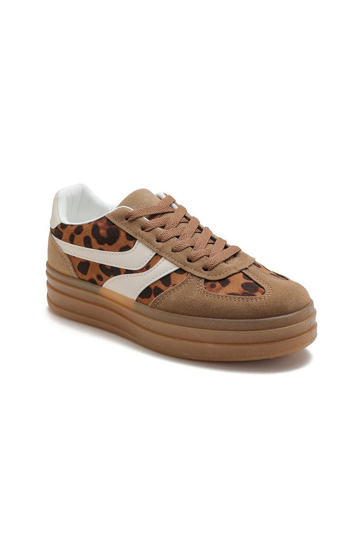 Brown sneaker with leopard print accents on a white background