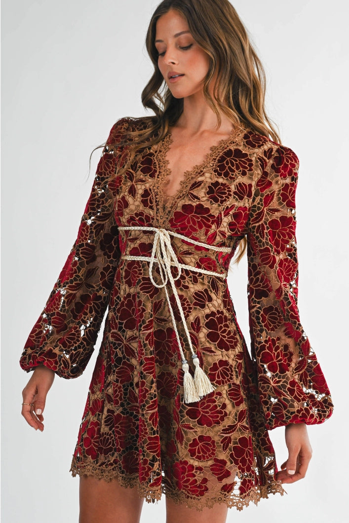 Woman wearing a floral dress with long sleeves on a white background