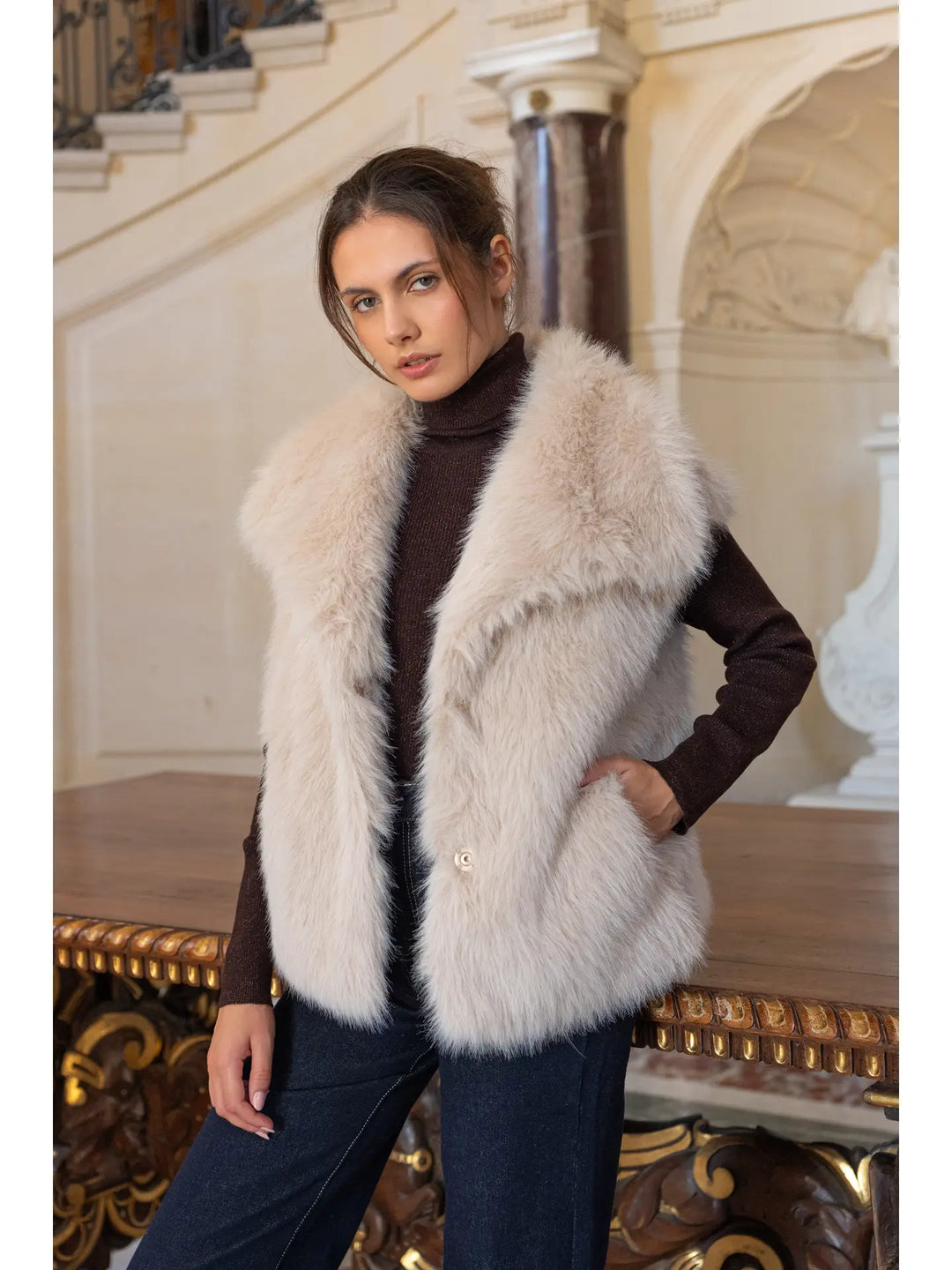 Woman wearing a fur vest in an elegant interior setting