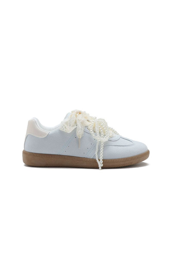 White sneaker with beige sole on a white background