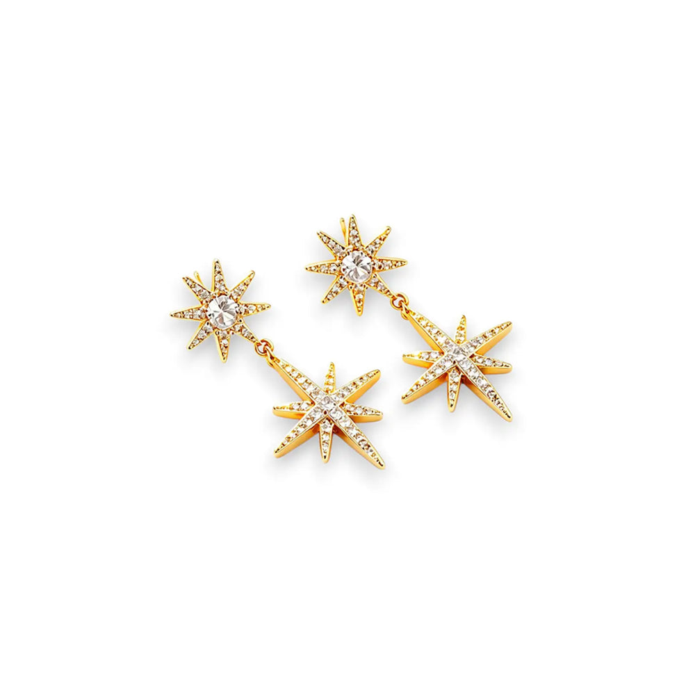 A pair of gold starburst dangle earrings with clear rhinestones, displayed on a clean white background.
