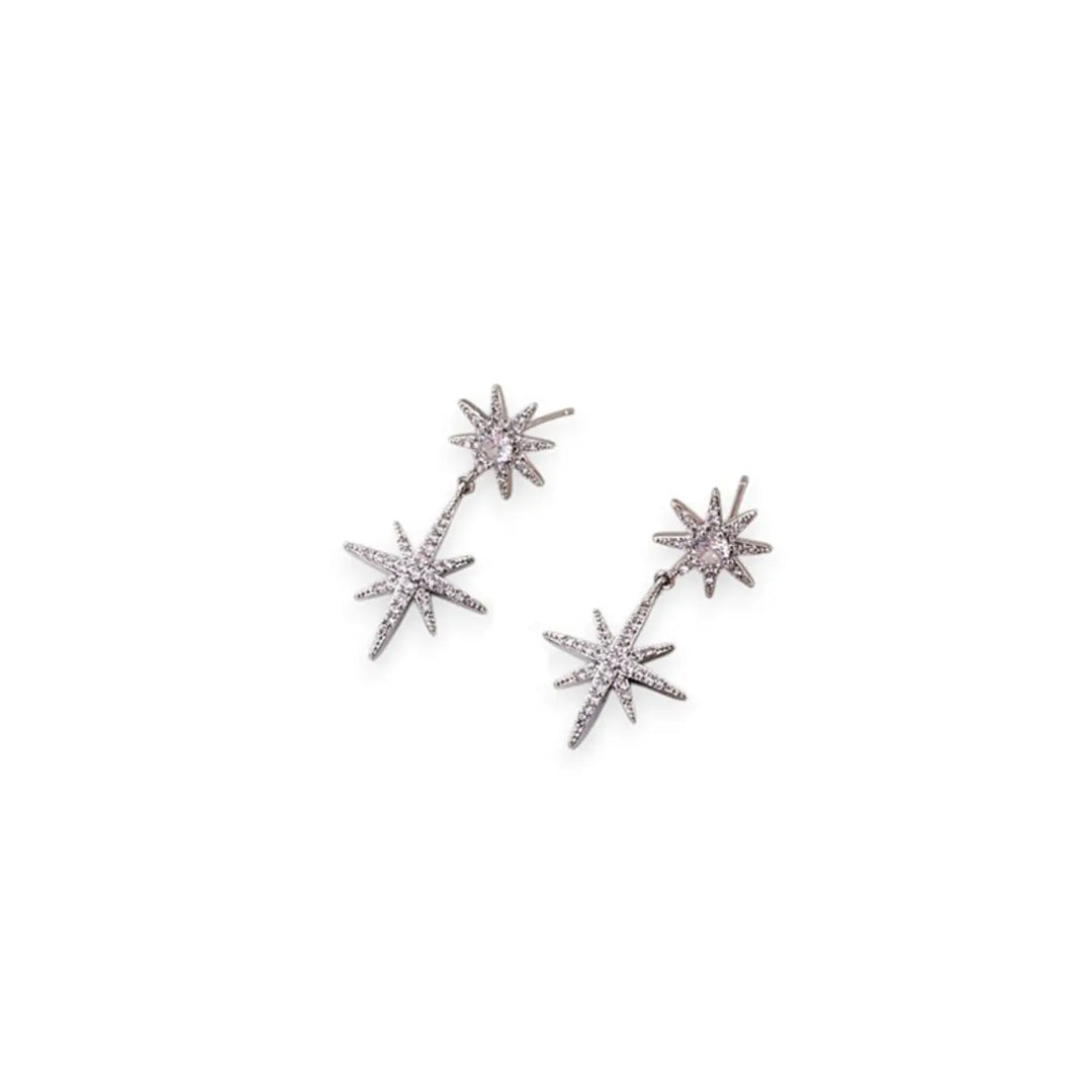 A pair of silver-toned dangle earrings featuring three-pointed starburst charms set with small clear stones and a central round pale pink stone, shown on a plain white background.