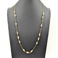 Gold necklace on a black background
