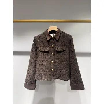 A brown tweed jacket with a dark brown collar and gold buttons, hanging on a wooden hanger against a light gray wall.