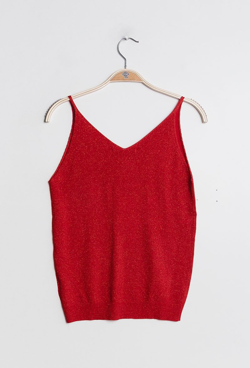 Red tank top on a hanger against a white background
