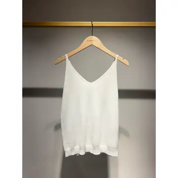 White tank top on a wooden hanger against a gray background