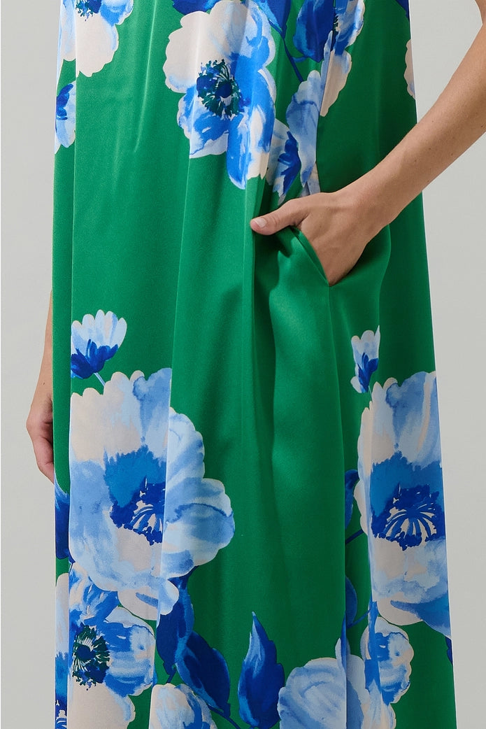 Green dress with blue floral pattern held by a person