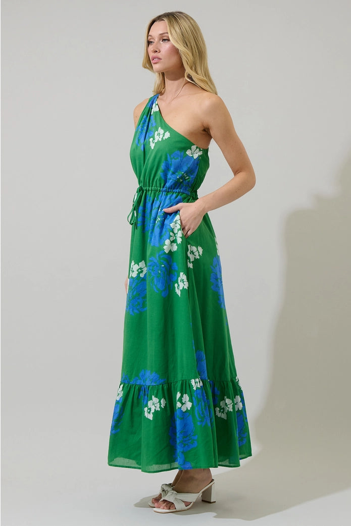 Woman wearing a green floral dress against a white background
