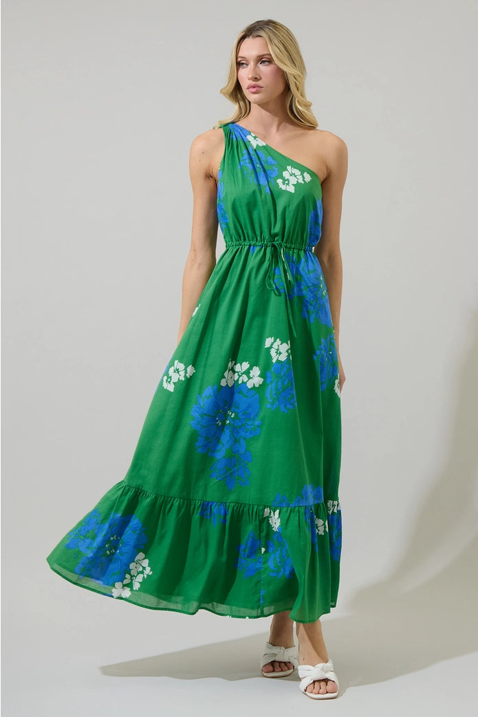 Woman wearing a green floral dress against a plain background