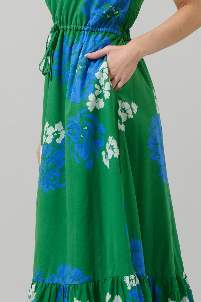 Green dress with blue floral pattern on a plain background