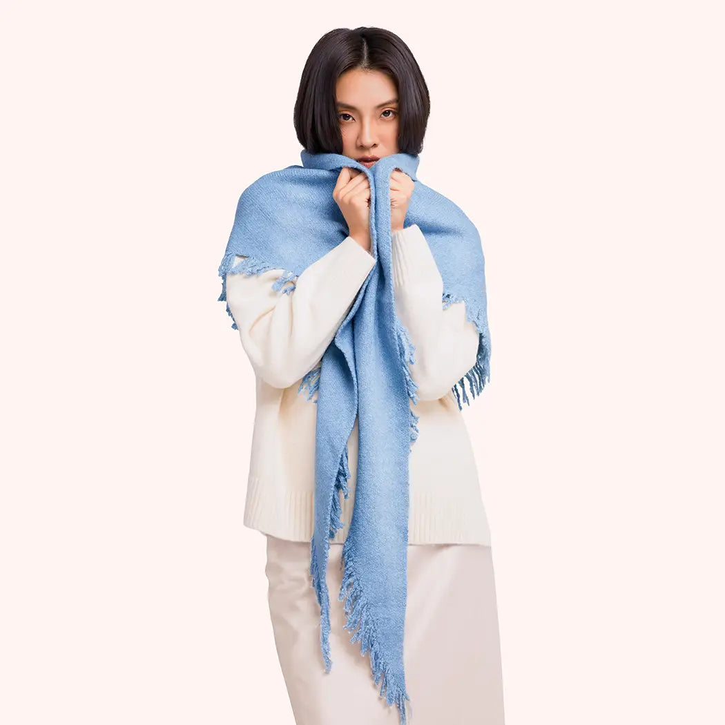 Woman wearing a blue scarf on a white background