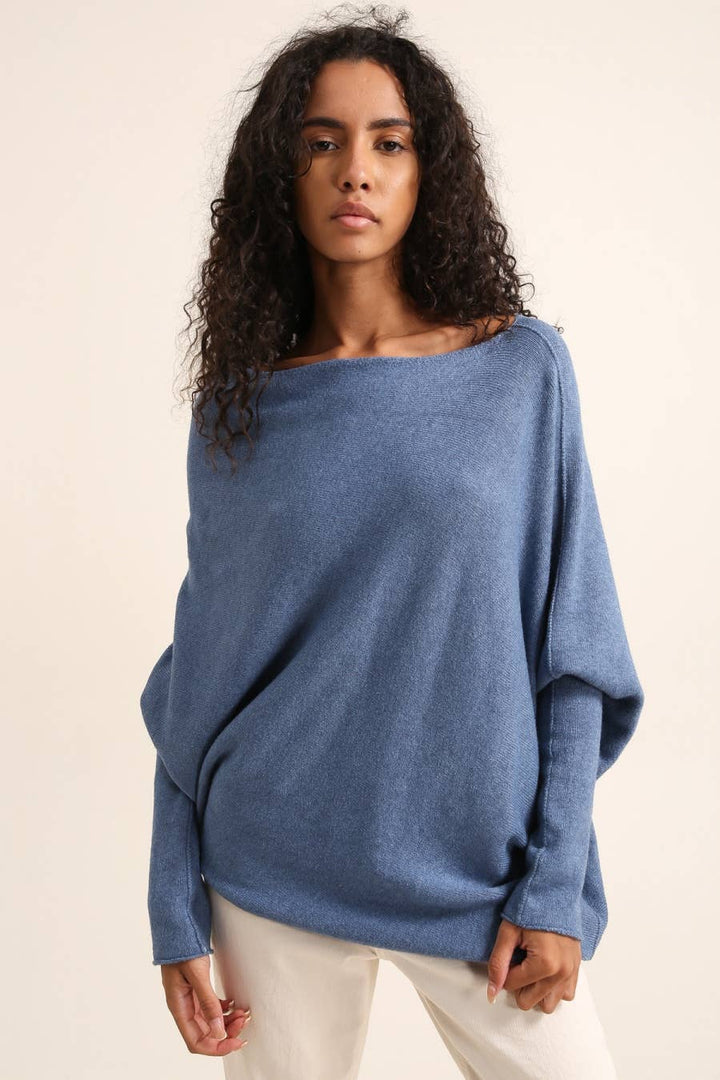 Woman wearing a blue sweater against a beige background
