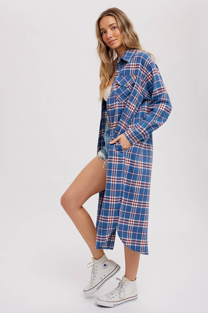 Woman wearing a blue plaid dress with a white background