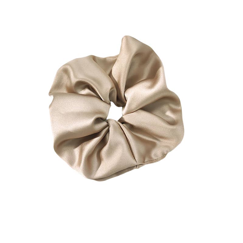 Beige satin scrunchie on a white background