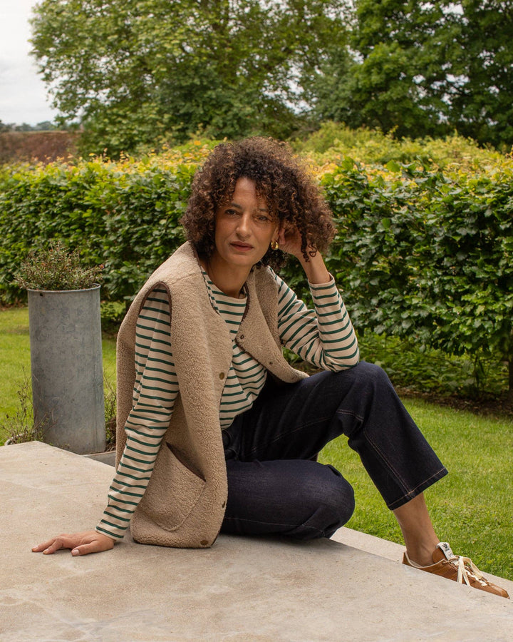 Woman sitting outdoors in a garden setting