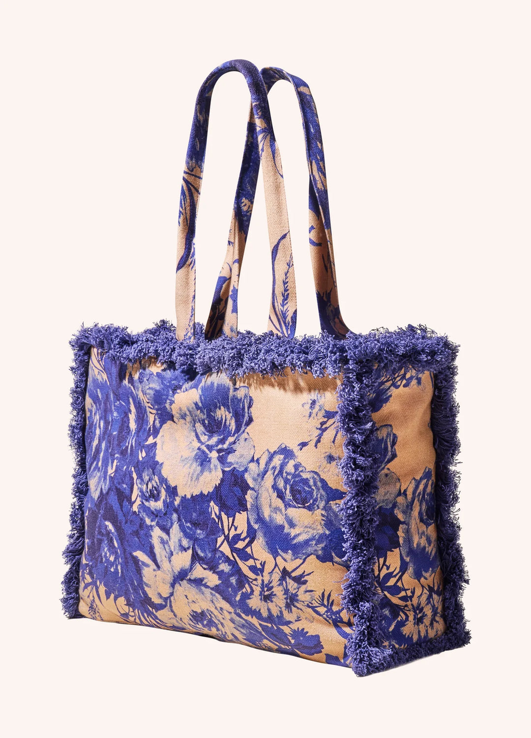 Tote bag with blue floral pattern and frayed edges on a white background
