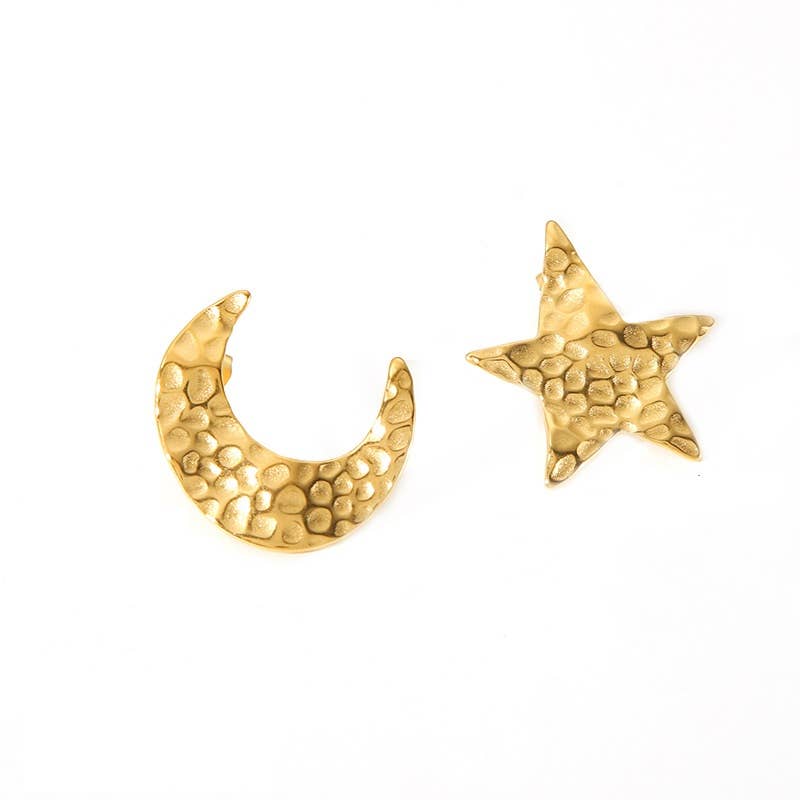 Gold star and crescent moon earrings on a white background