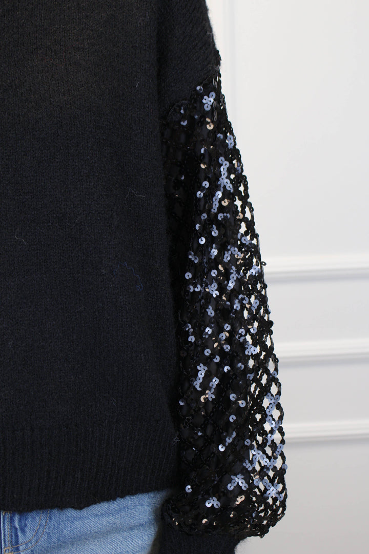 Black sweater with sequin sleeves on a white background