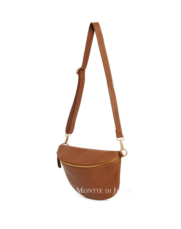 Brown leather bag with a strap on a white background