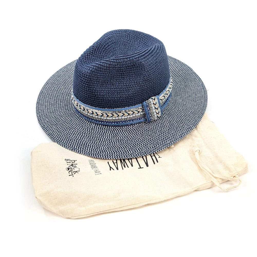 Blue straw hat with decorative band on a beige cloth with 'HATAWAY' branding.