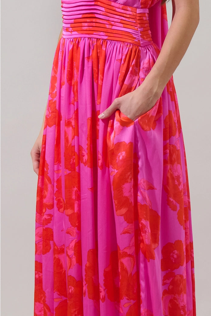 Close-up of a pink and red floral dress with a plain background