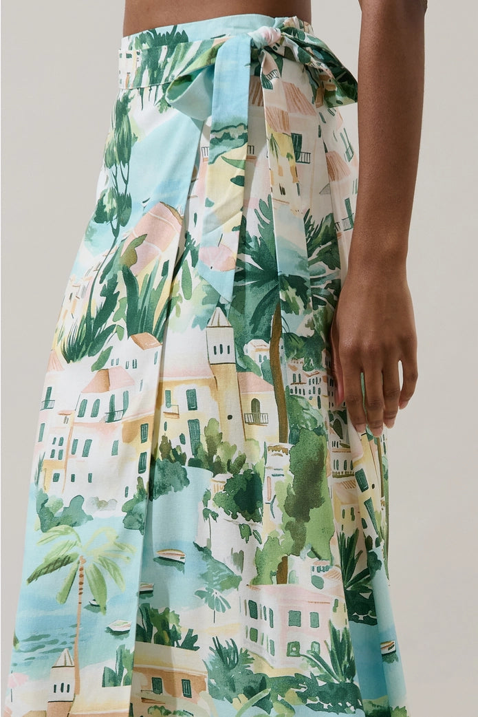 Skirt with tropical print featuring palm trees and buildings on a neutral background