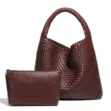 Brown woven handbag and matching pouch on a white background