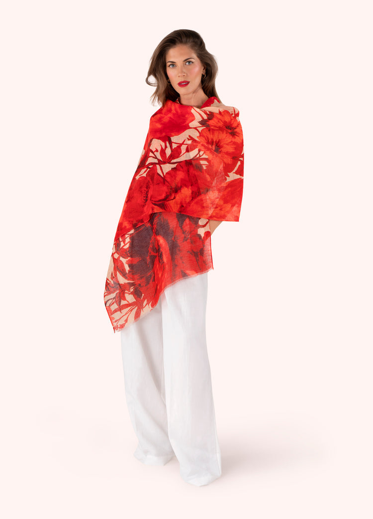 Woman wearing a red floral scarf on a white background