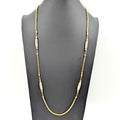 Gold chain necklace on a white background