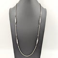 Silver necklace on a black background