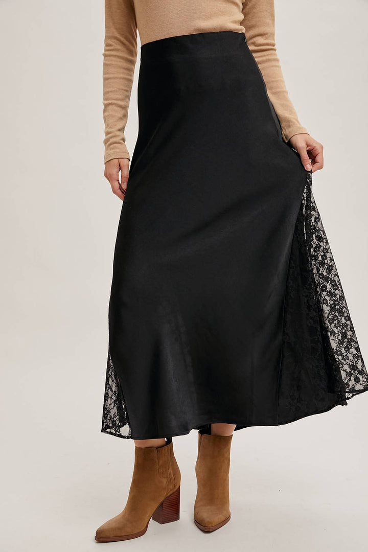 Black skirt with lace trim worn by a person on a plain background