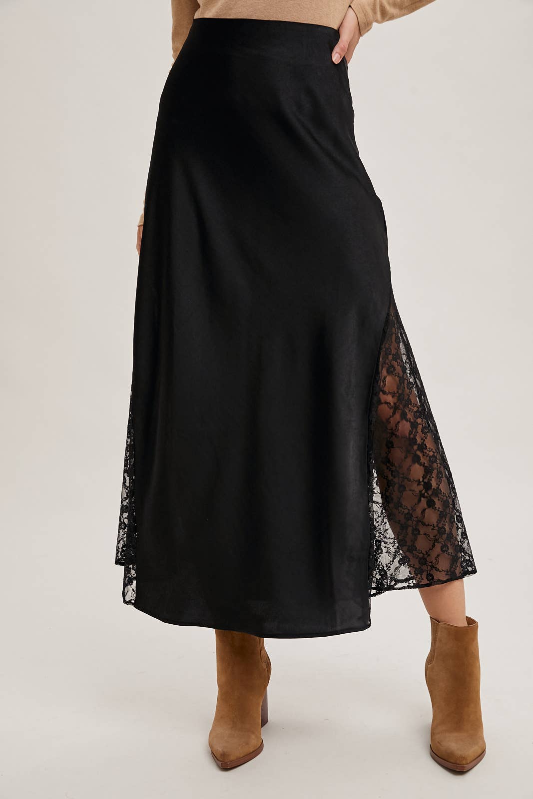 Black skirt with lace detailing worn by a person on a white background