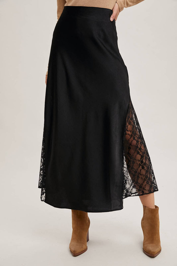 Black skirt with lace detailing worn by a person on a white background