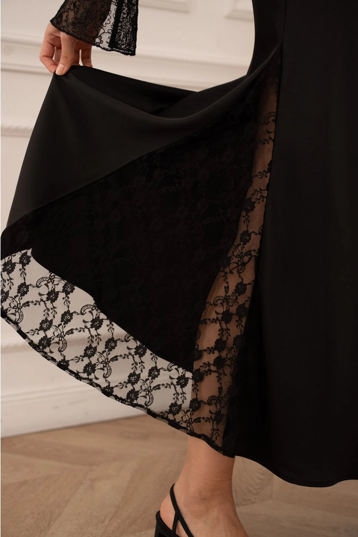 Black skirt with lace detailing on a neutral background
