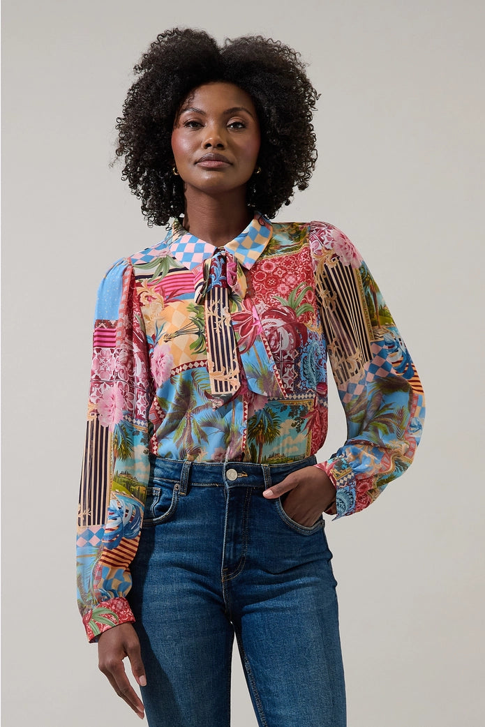 Woman wearing a colorful patterned shirt with a plain background