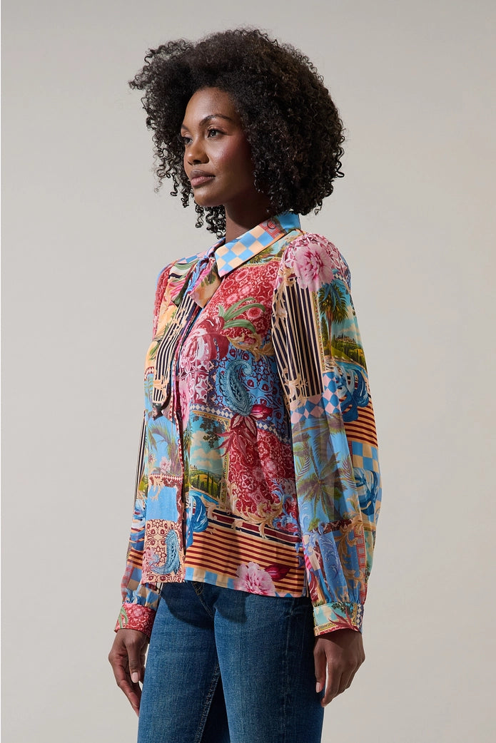 Woman wearing a colorful patterned shirt against a plain background