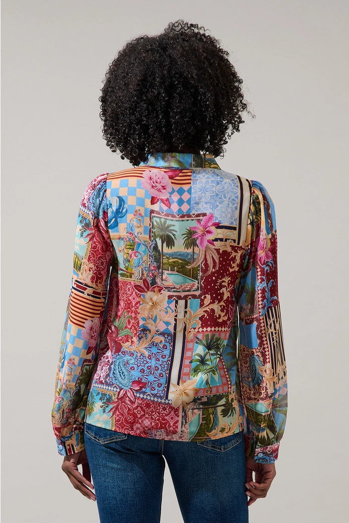 Person wearing a colorful patchwork jacket on a plain background