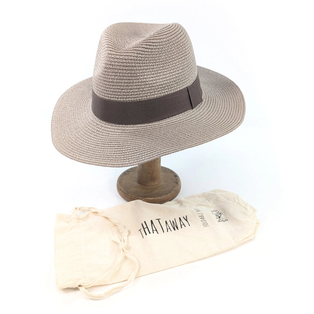 Beige straw hat with brown band on a wooden stand, accompanied by a beige carrying bag labeled 'HATAWAY' on a white background.
