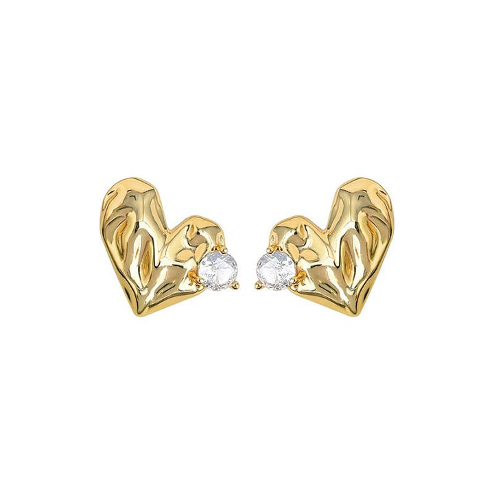 Gold heart-shaped earrings with clear gemstones on a white background