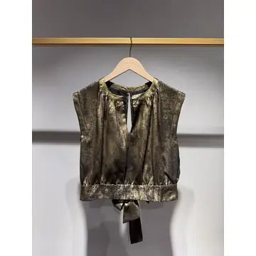 Green tie-dye top on a hanger against a gray background